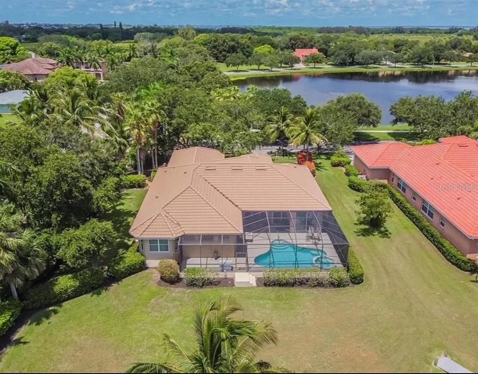 An aerial view of a house with a screened-in pool and a tile roof — 1704 AMBERWYND CIRCLE W, PALMETTO, FL