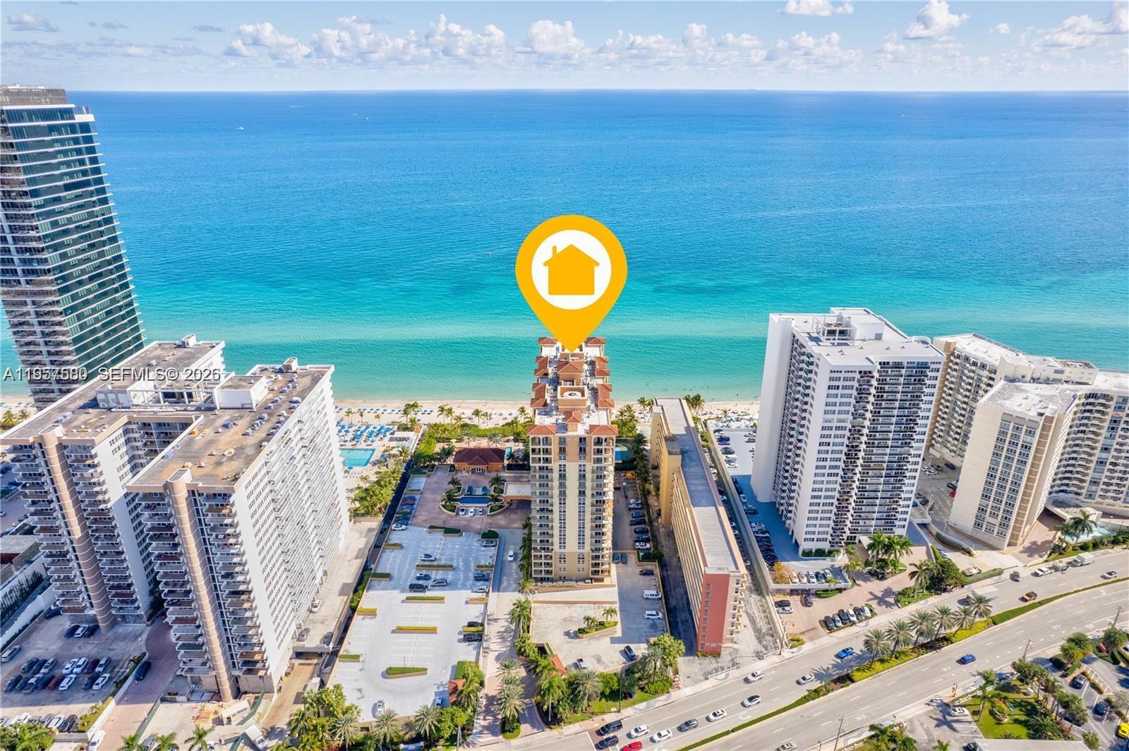 An aerial view shows a beachfront condominium building surrounded by parking lots and neighboring towers — 2080 S Ocean Dr # 506, Hallandale Beach FL 33009, HALLANDALE BEACH, FL