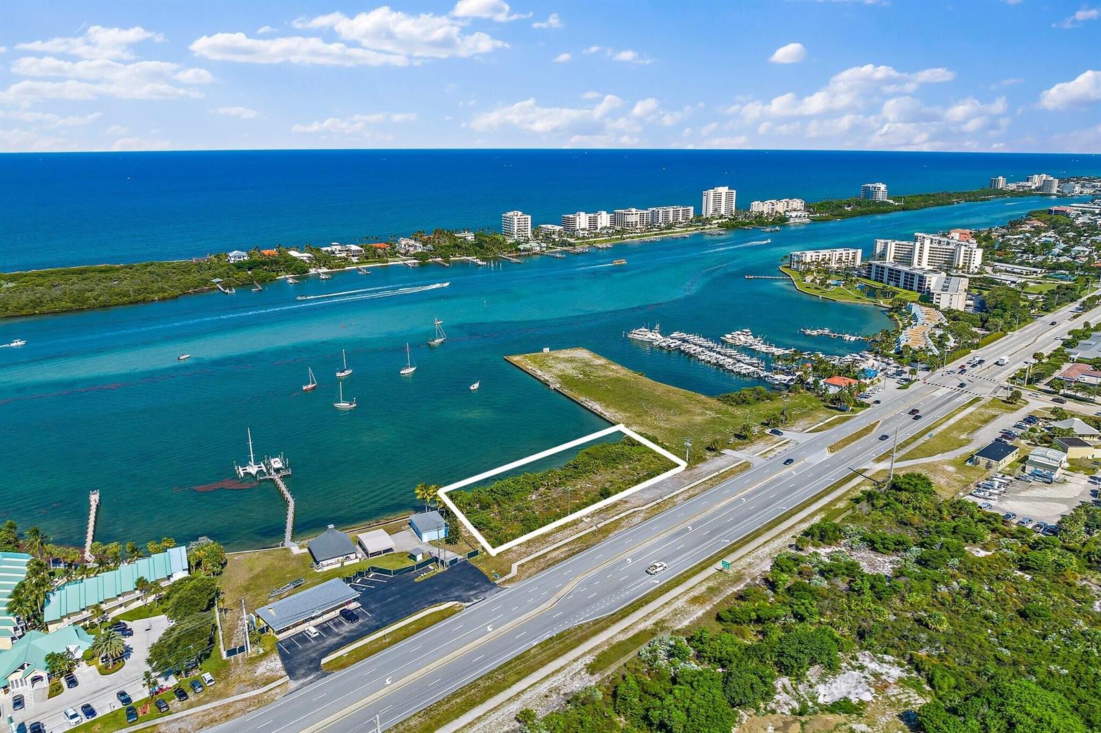 An aerial view shows a vacant rectangular waterfront lot bordered by a highway and water — 0000 SE Federal Highway, Jupiter FL 33469, JUPITER, FL