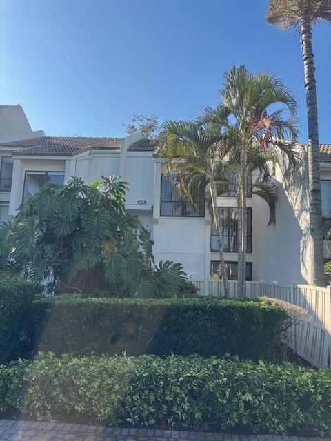 A multi-story residential building exterior with a large monstera plant and palm trees — 808 Bridgewood Place # 808, Boca Raton FL 33434, BOCA RATON, FL
