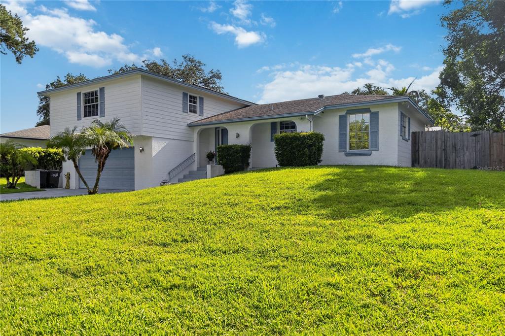 A two-story white house with blue shutters and a large front lawn — 656 LITTLE WEKIVA ROAD, ALTAMONTE SPRINGS, FL