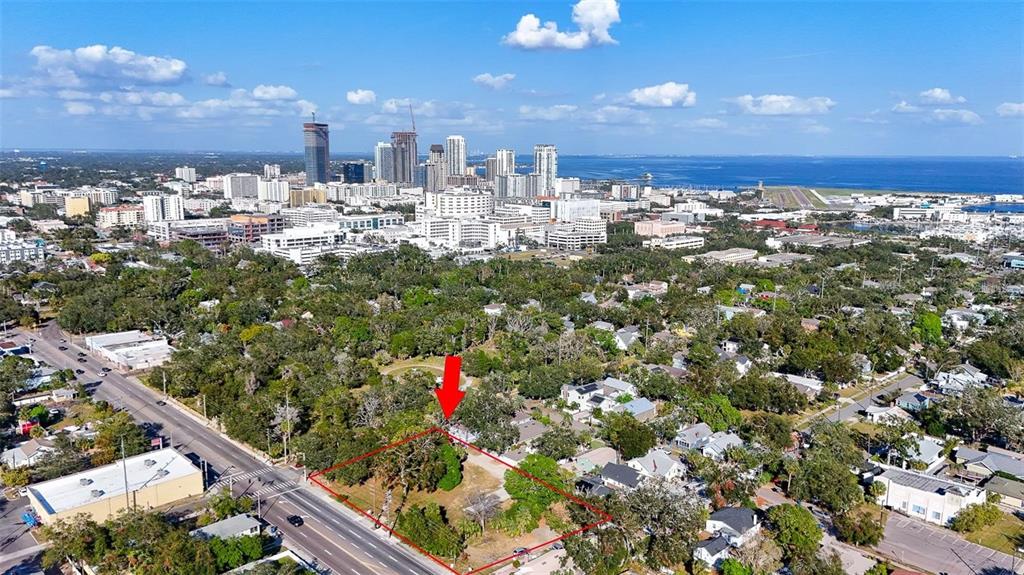 An aerial view shows a vacant, rectangular lot outlined in red near a city skyline — 1118 S DR MARTIN LUTHER KING JR STREET S, ST PETERSBURG, FL