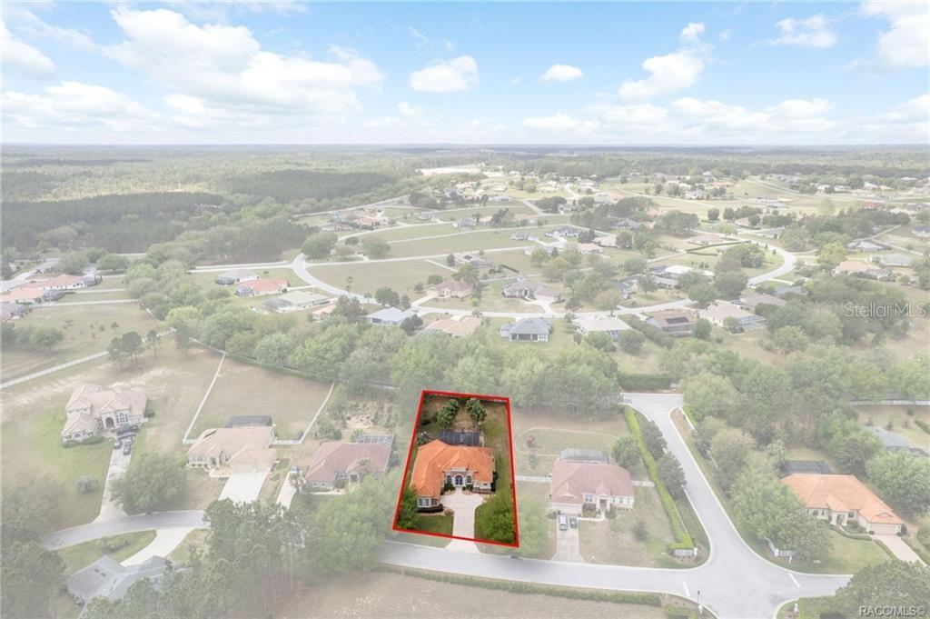 An aerial view shows a single-family home with a red roof outlined in red — 291 S PALADINN CIRCLE, INVERNESS, FL