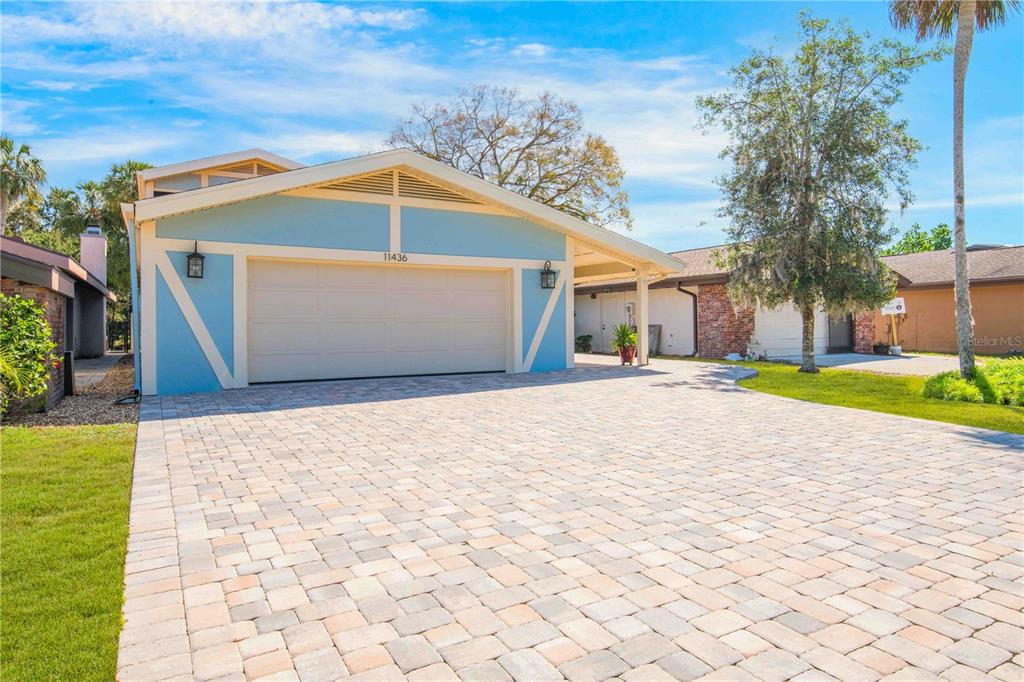 A light blue house with a paved driveway and a two-car garage — 11436 W CLUBVIEW DRIVE, HOMOSASSA, FL