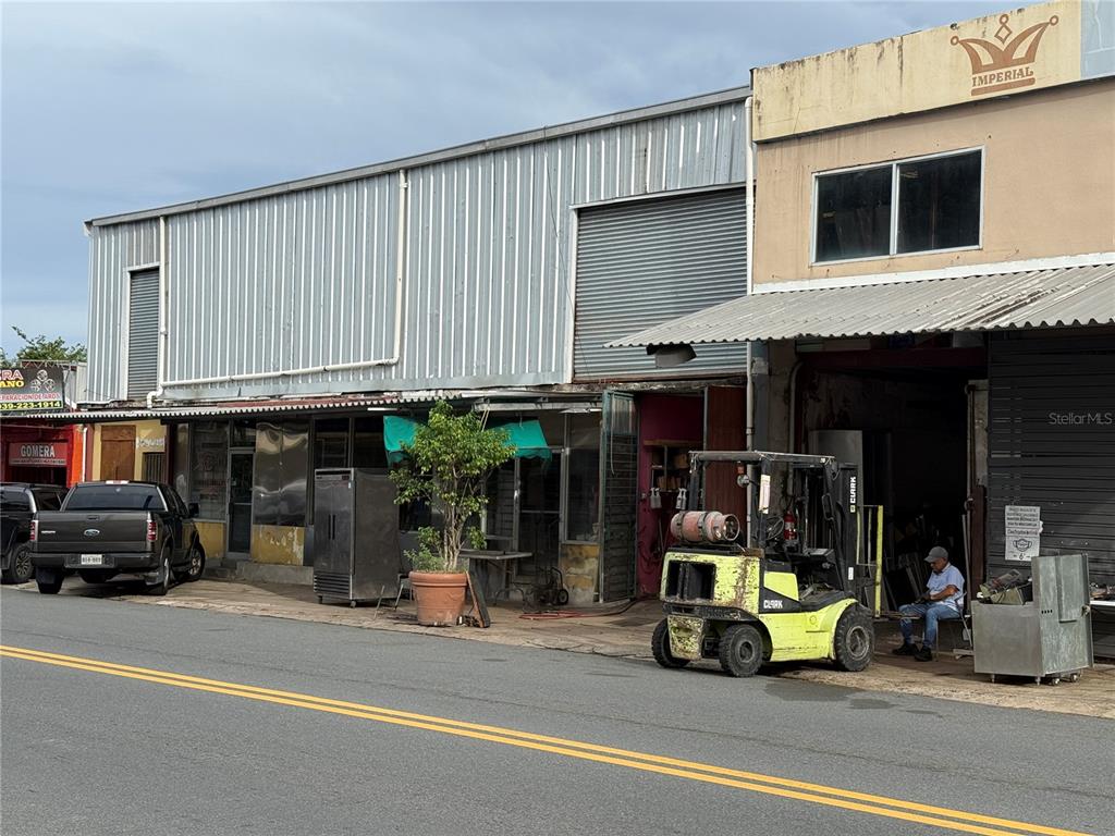 A commercial building exterior features a forklift, a parked truck, and a small potted tree — 1328 AMERICO MIRANDA AVENUE UNIT 1328, SAN JUAN, PR