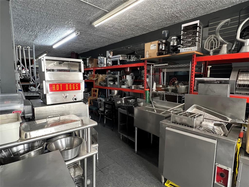 A commercial kitchen space features stainless steel equipment, shelving units, and a hot dog warmer — 1328 AMERICO MIRANDA AVENUE UNIT 1328, SAN JUAN, PR