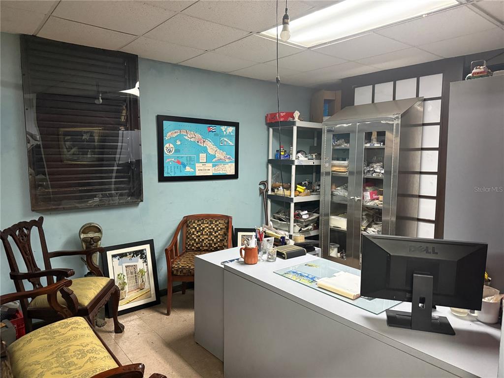 An office space features a desk, chairs, a metal storage cabinet, and a wall map — 1328 AMERICO MIRANDA AVENUE UNIT 1328, SAN JUAN, PR