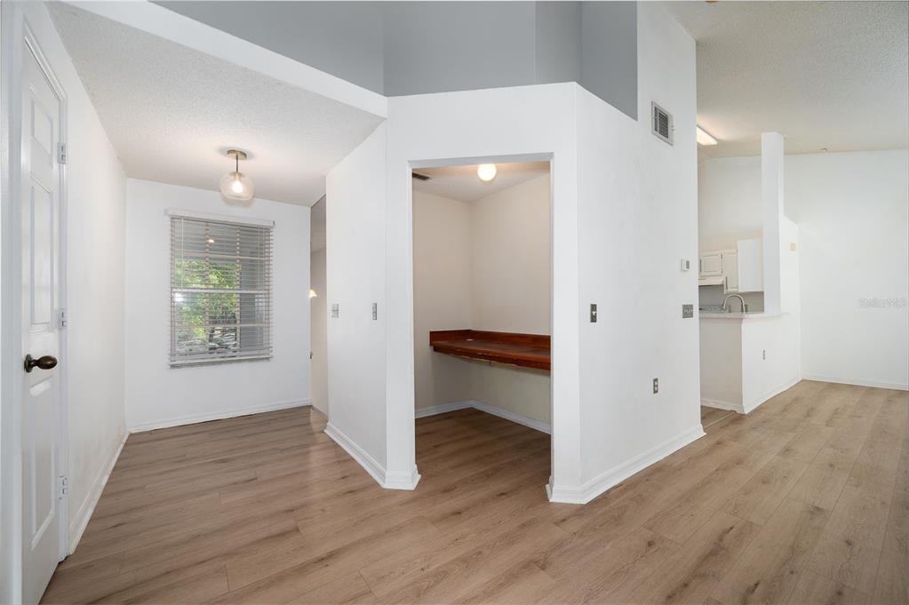 An interior view showing a dining area, a small built-in desk nook, and a kitchen — 10000 SW 52ND AVENUE UNIT 188, GAINESVILLE, FL
