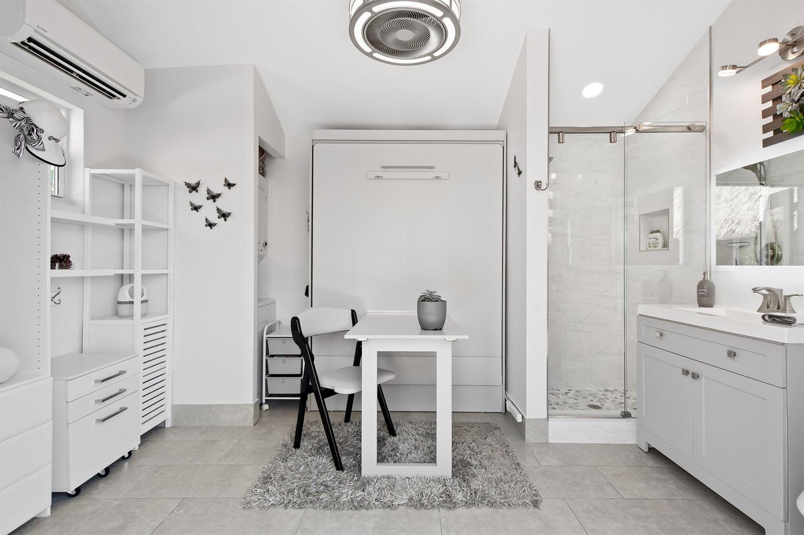 A studio room features a Murphy bed, a small dining table, and an attached bathroom — 110 S Cortez Drive # 110, Margate FL 33068, MARGATE, FL