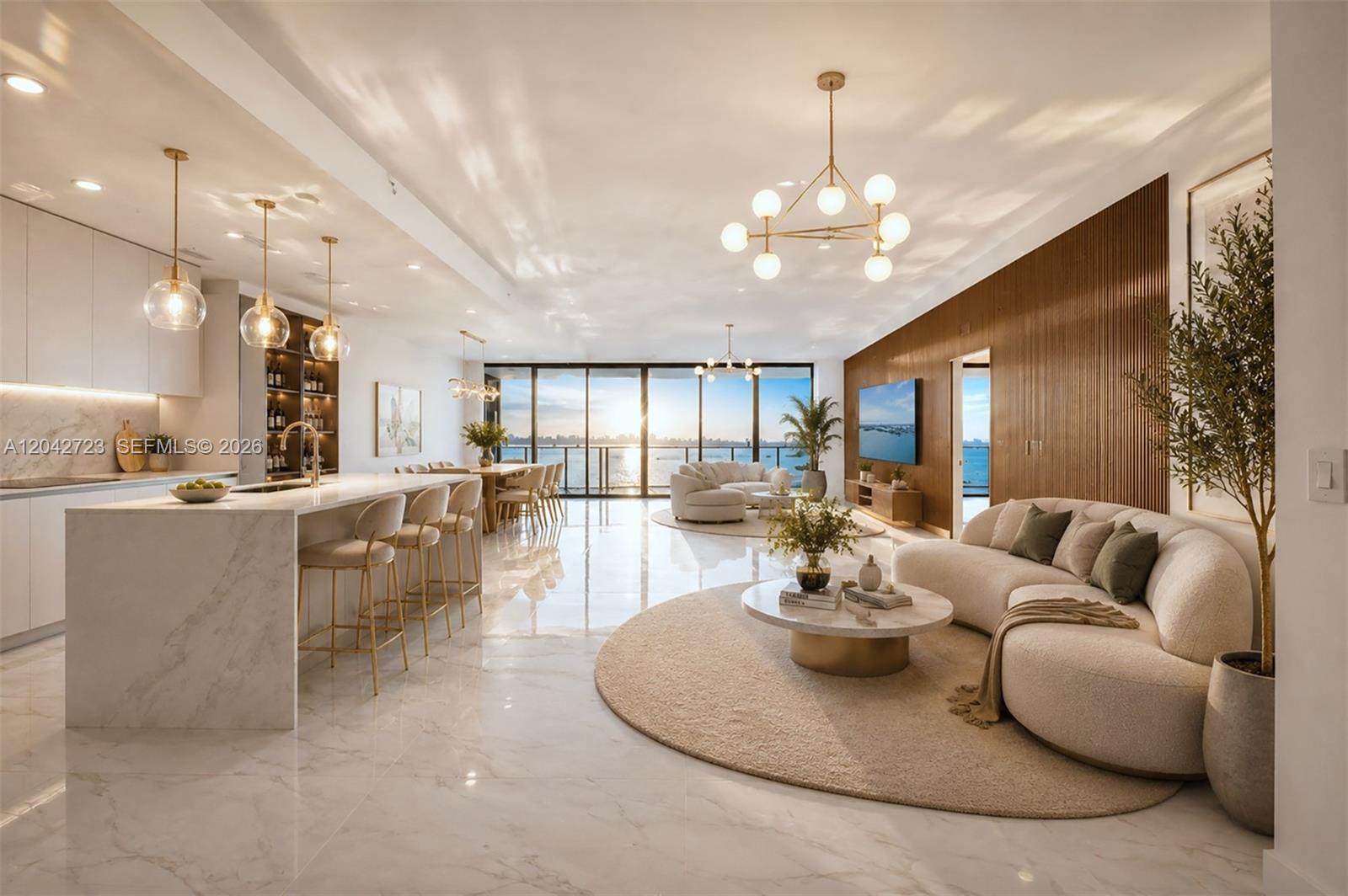 An open-concept living and kitchen area features marble floors, a large island, and waterfront views — 700 NE 24th St # 4702, Miami FL 33137, MIAMI, FL