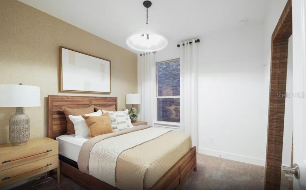 A bedroom features a wooden bed frame, a textured accent wall, and a window with curtains — 4782 W BLUE STAR COURT, NORTH PORT, FL