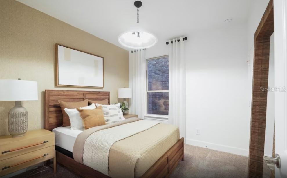 A bedroom features a wooden bed frame, a tan accent wall, and a large window — 4782 W BLUE STAR COURT, NORTH PORT, FL