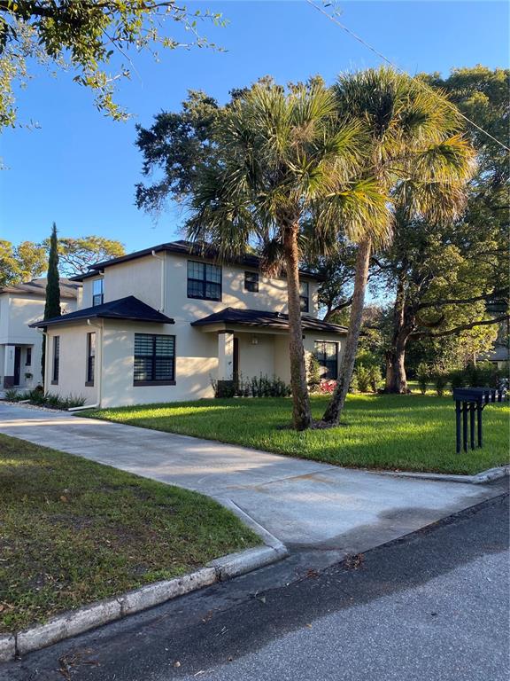 A two-story house with a concrete driveway and palm trees in the front yard — 2251 NAIRN DRIVE, WINTER PARK, FL