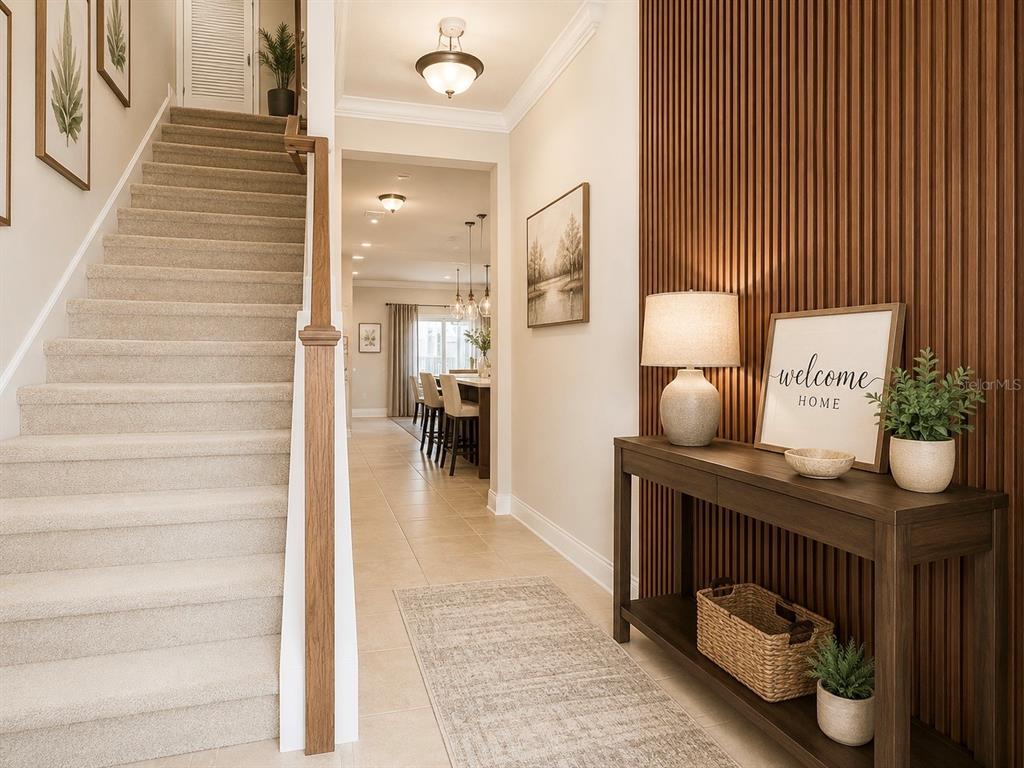 A foyer features a carpeted staircase, a wood-slatted accent wall, and a console table — 2916 CHANTILLY AVENUE, KISSIMMEE, FL