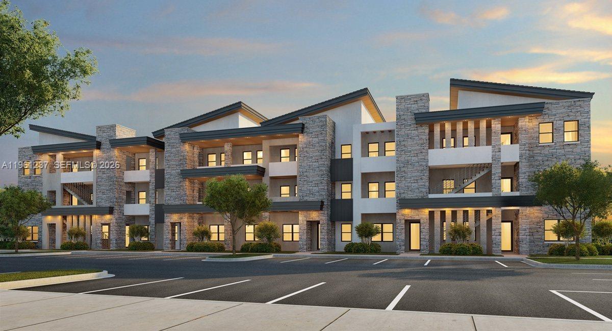 A digital rendering of a modern multi-story apartment building with stone and stucco exterior finishes — 7831 NW 104th Ave # 32, Doral FL 33178, DORAL, FL