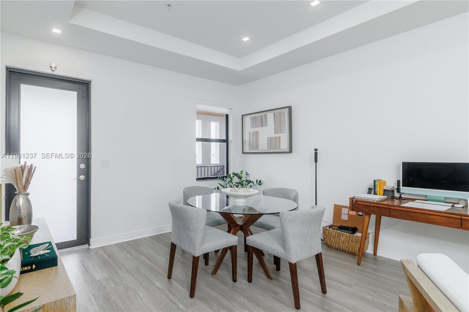 A dining area features a glass-topped table, four gray chairs, and a wooden desk — 7831 NW 104th Ave # 32, Doral FL 33178, DORAL, FL