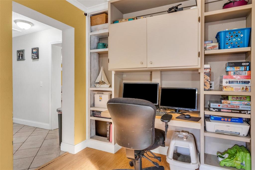 A home office nook features built-in shelving, a desk with two monitors, and a rolling chair — 202 SAINT LUCIE ROAD, WINTER HAVEN, FL