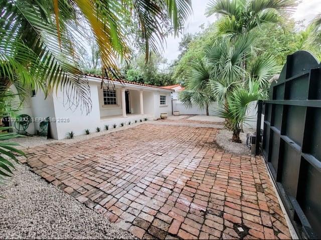 A white house with a brick driveway and palm trees in the front yard — 3685 SW 1st Ave, Miami FL 33145, MIAMI, FL
