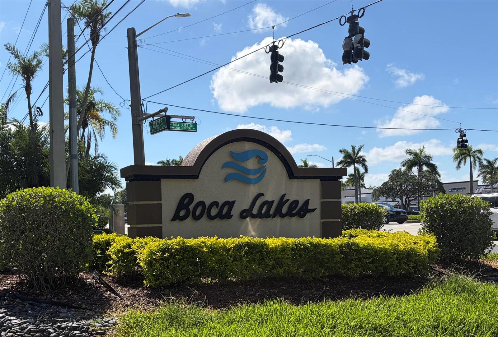 A sign for Boca Lakes stands in front of landscaping under a blue sky — 20928 Sedgewick Drive # 399, Boca Raton FL 33433, BOCA RATON, FL