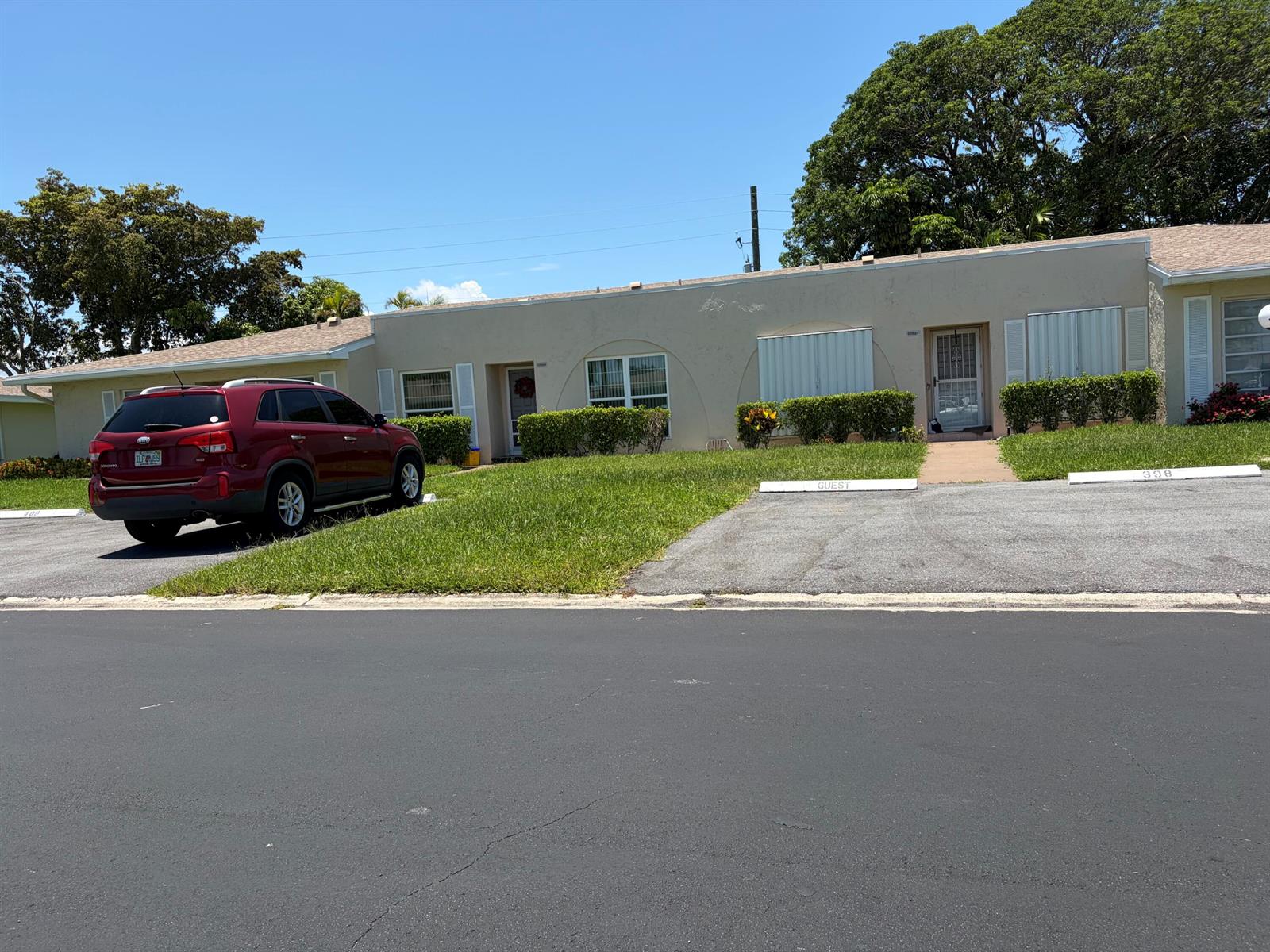 A one-story residential building with a red SUV parked in front on a sunny day — 20928 Sedgewick Drive # 399, Boca Raton FL 33433, BOCA RATON, FL
