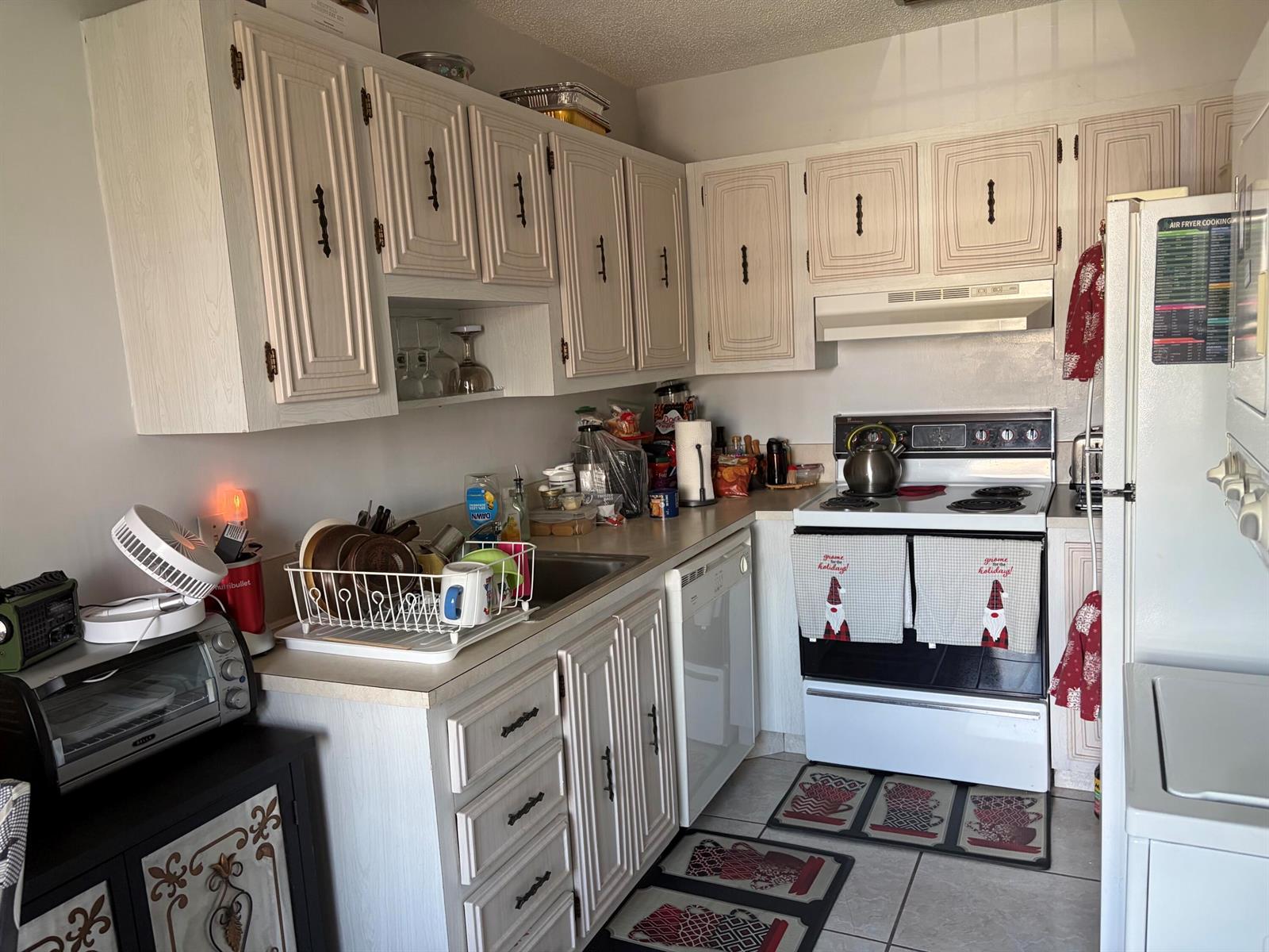 A kitchen featuring white wood-grain cabinets, a white stove, and a dishwasher — 20928 Sedgewick Drive # 399, Boca Raton FL 33433, BOCA RATON, FL