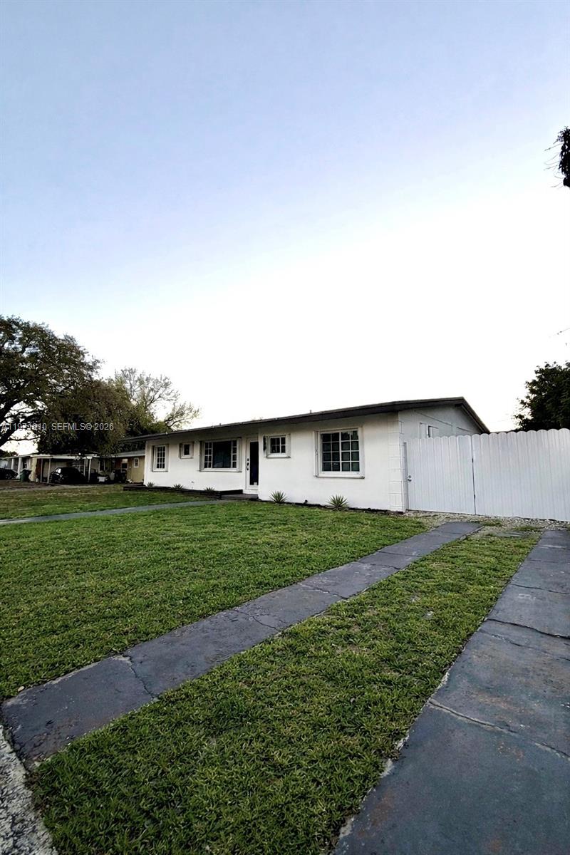 A single-story white house with a grass lawn and a concrete driveway — 19730 NW 3rd Ct, Miami Gardens FL 33169, MIAMI GARDENS, FL