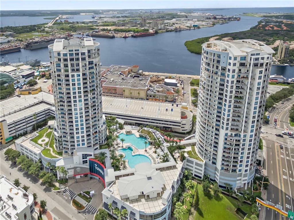An aerial view shows two high-rise residential towers with a shared pool deck and parking — 449 S 12TH STREET UNIT 1904, TAMPA, FL