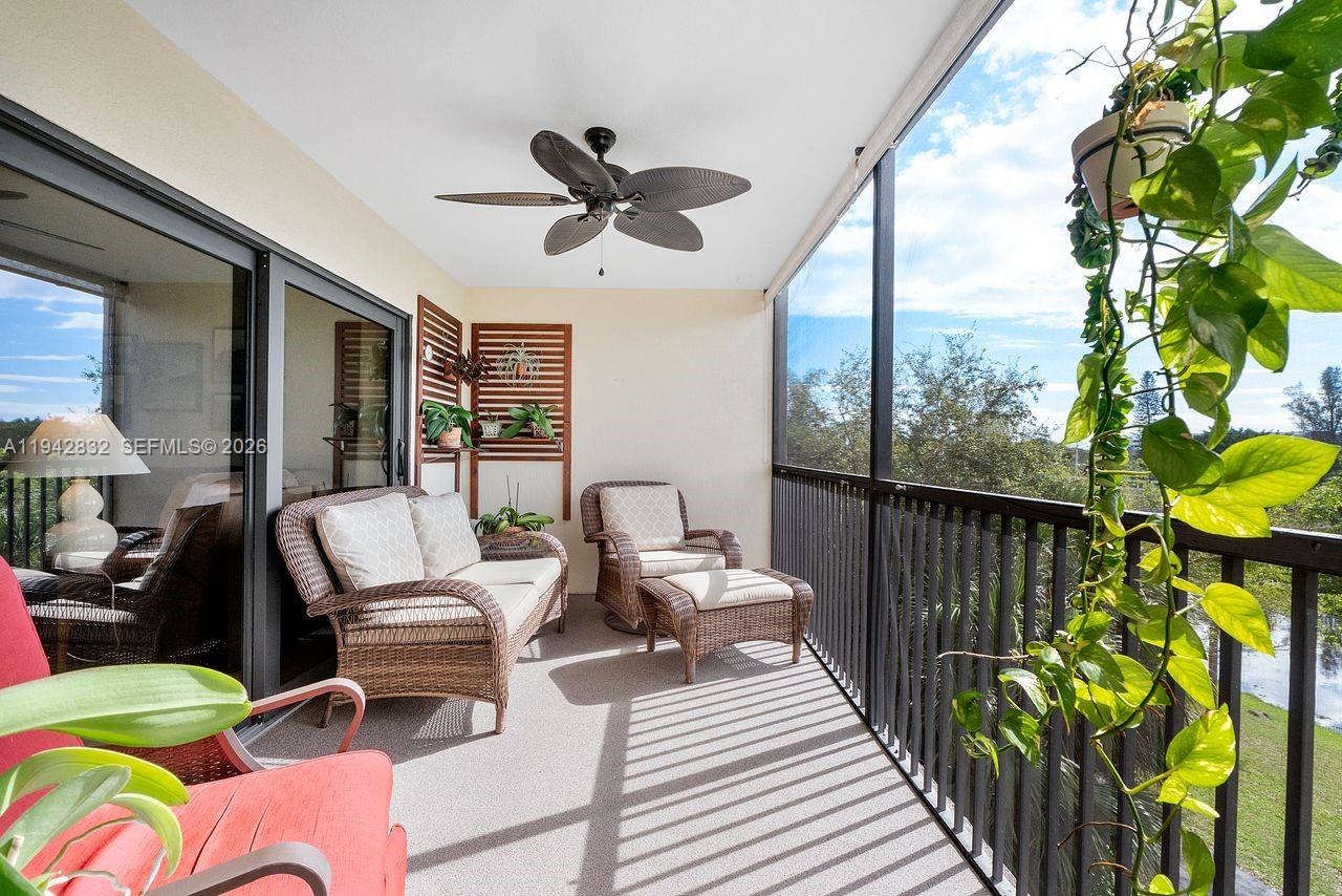 A dining area with a tiled table sits adjacent to a living room with carpet — 2200 S Cypress Bend Dr # 406, Pompano Beach FL 33069, POMPANO BEACH, FL