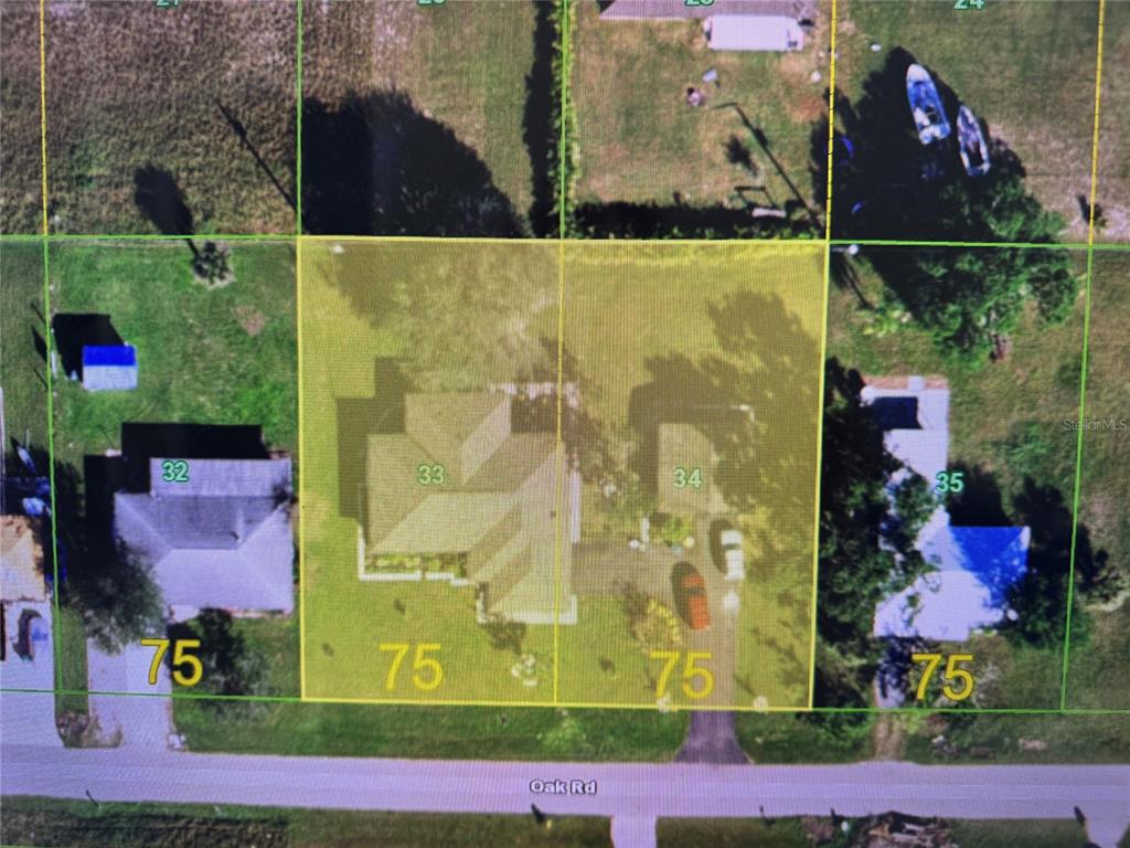 This is a map showing two adjacent residential lots, numbered 33 and 34, on Oak Road — 30048 OAK ROAD, PUNTA GORDA, FL