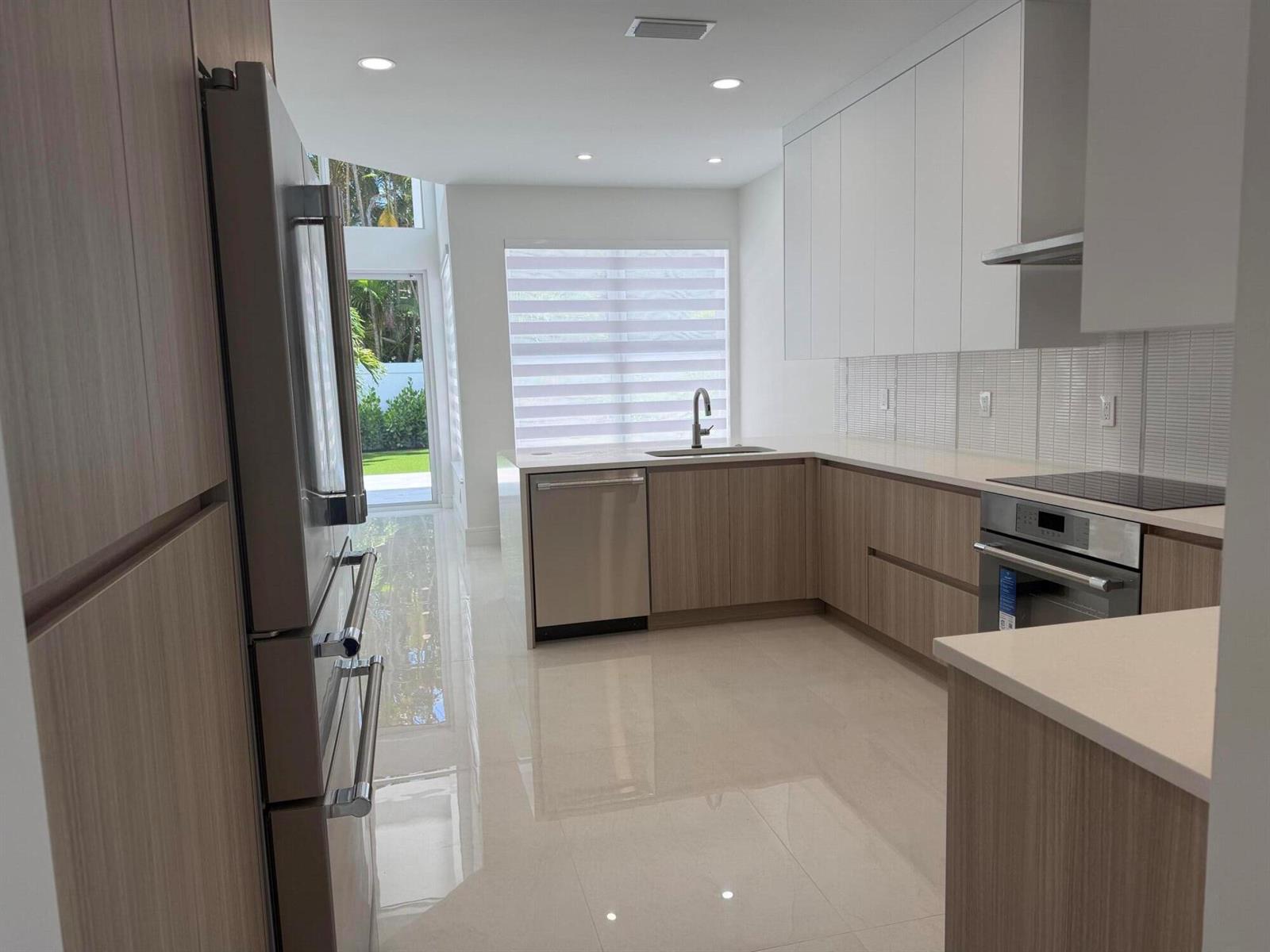 A high-ceilinged living room features white tile floors, a neutral sofa, and a round mirror — 3368 NW 53rd Circle, Boca Raton FL 33496, BOCA RATON, FL