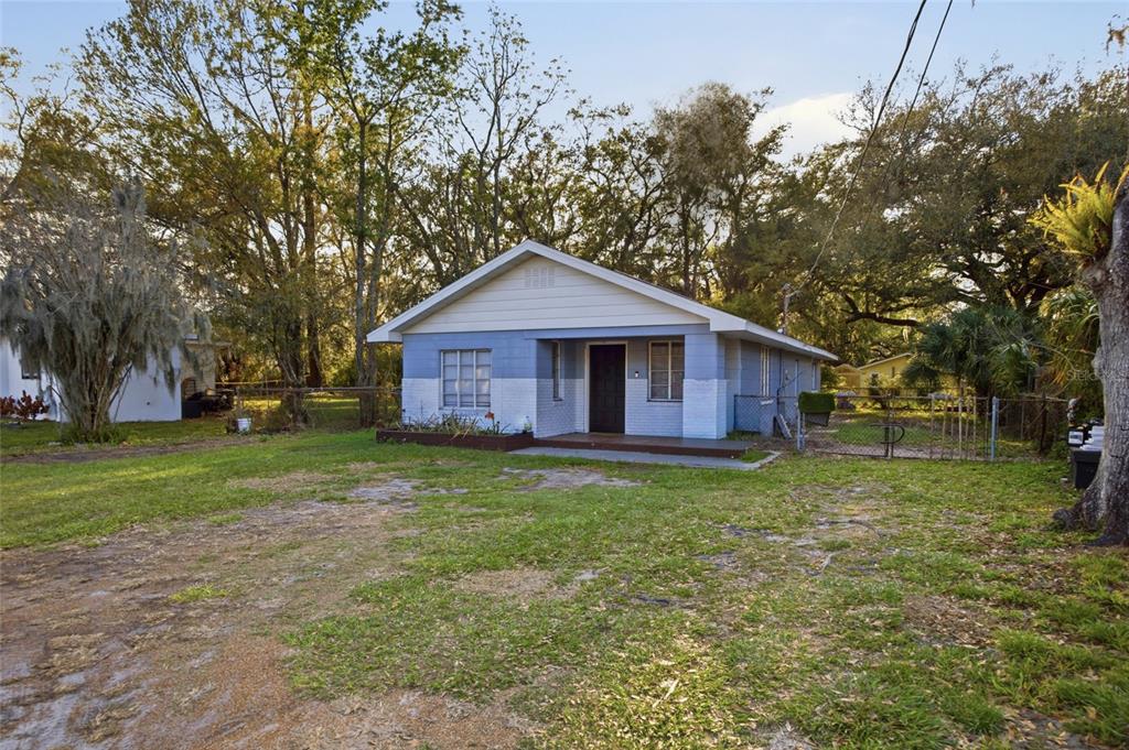 A single-story house with a blue and white exterior sits on a grassy lot — 907 CENTER STREET, PLANT CITY, FL