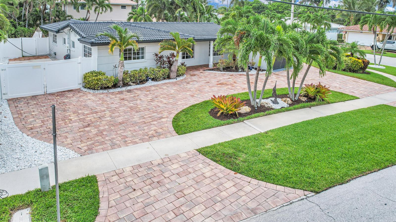 An exterior view of a single-story house with a paved driveway and landscaped front yard — 701 Appleby Street, Boca Raton FL 33487, BOCA RATON, FL