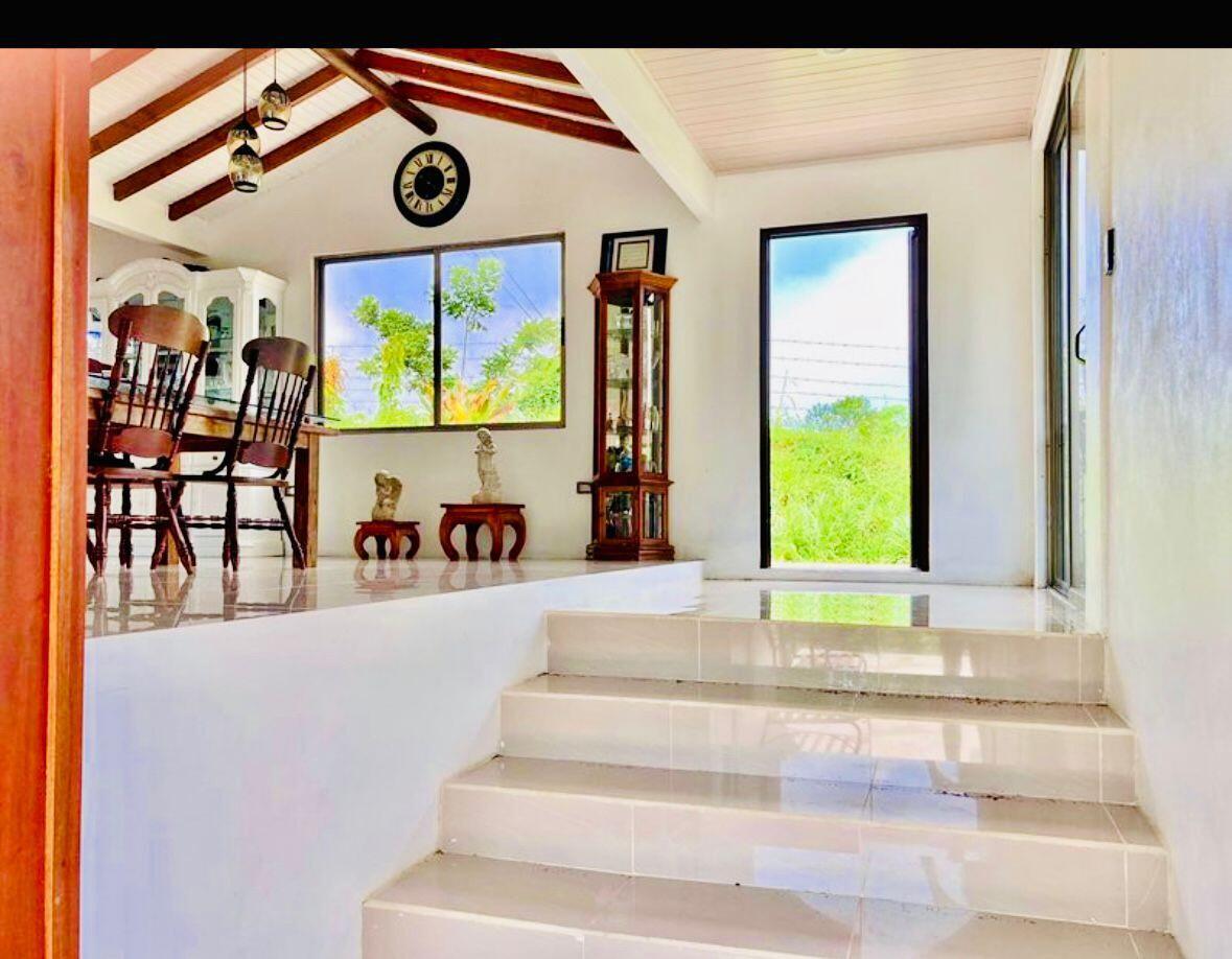 A bright room with tiled floors and steps leading up to a dining area — 141 N El Tanque Fortuna San Carlos Street, FL
