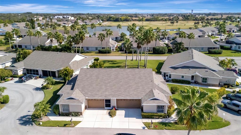 An aerial view shows a duplex residential building with gray roofs and attached garages — 2905 CAPTAINS COURT UNIT 0, PALMETTO, FL