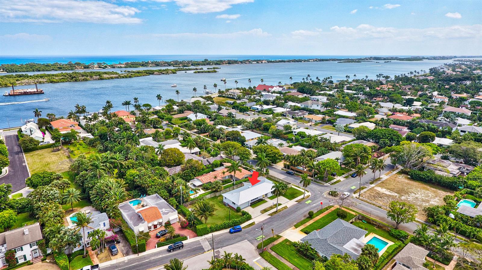 An aerial view shows a residential neighborhood with a red arrow pointing to a house — 4300 Washington Road, West Palm Beach FL 33405, WEST PALM BEACH, FL