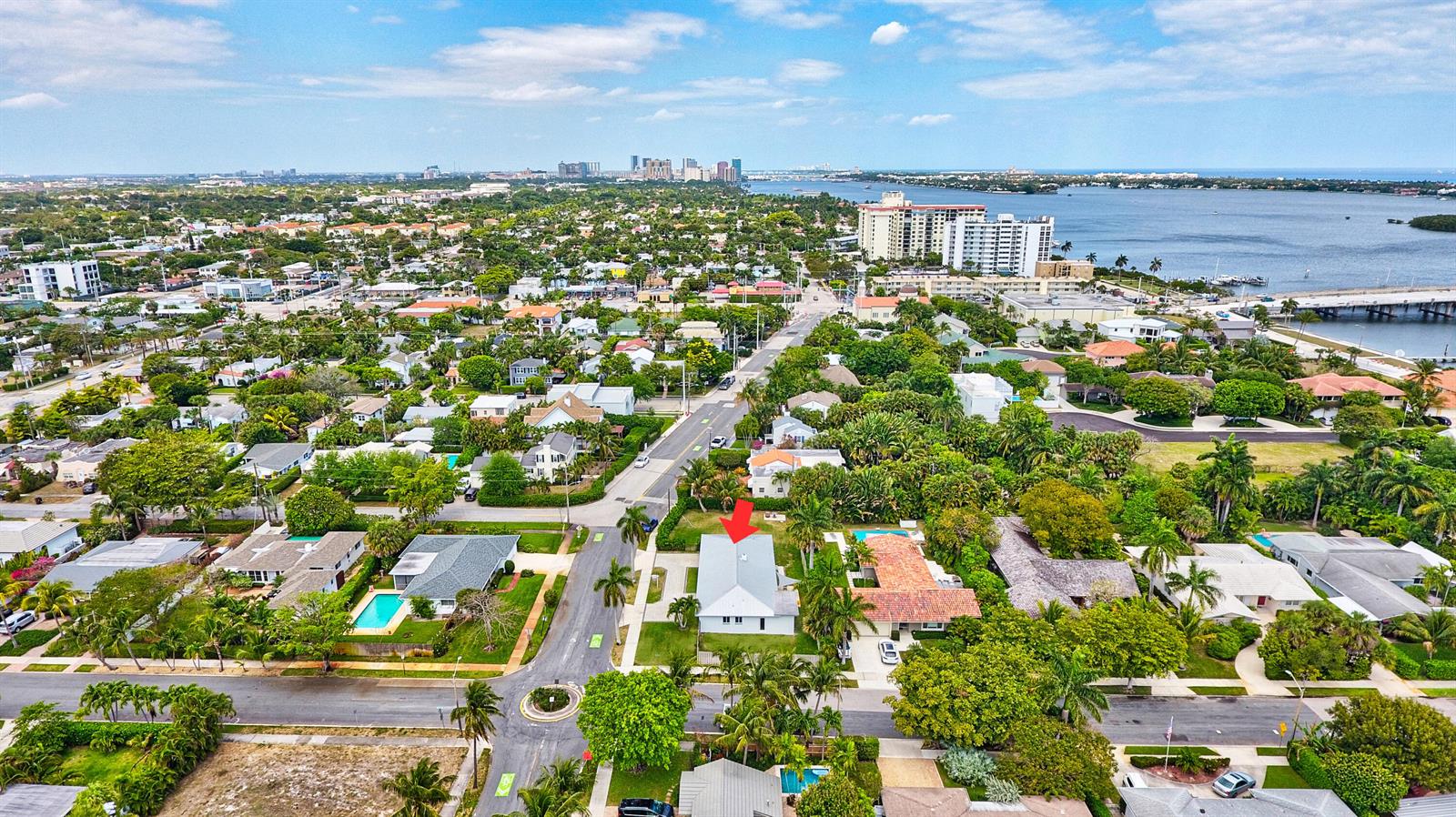 An aerial view shows a residential neighborhood with a red arrow pointing to a house — 4300 Washington Road, West Palm Beach FL 33405, WEST PALM BEACH, FL