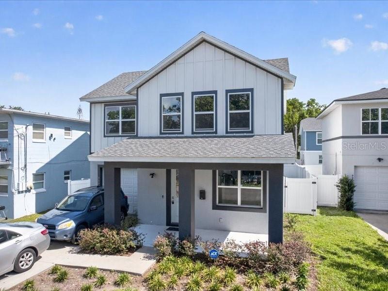 A two-story house with white vertical siding and a covered front porch — 909 RANDALL STREET, ORLANDO, FL