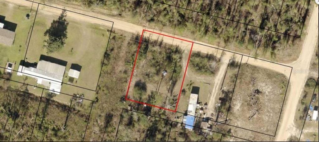 An aerial view shows a vacant, rectangular plot of land outlined in red near roads — 2ND STREET, FOUNTAIN, FL