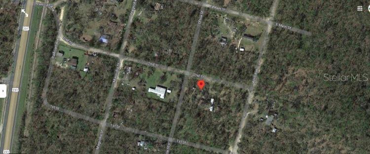 This is an aerial map view of a residential lot marked with a red pin — 2ND STREET, FOUNTAIN, FL