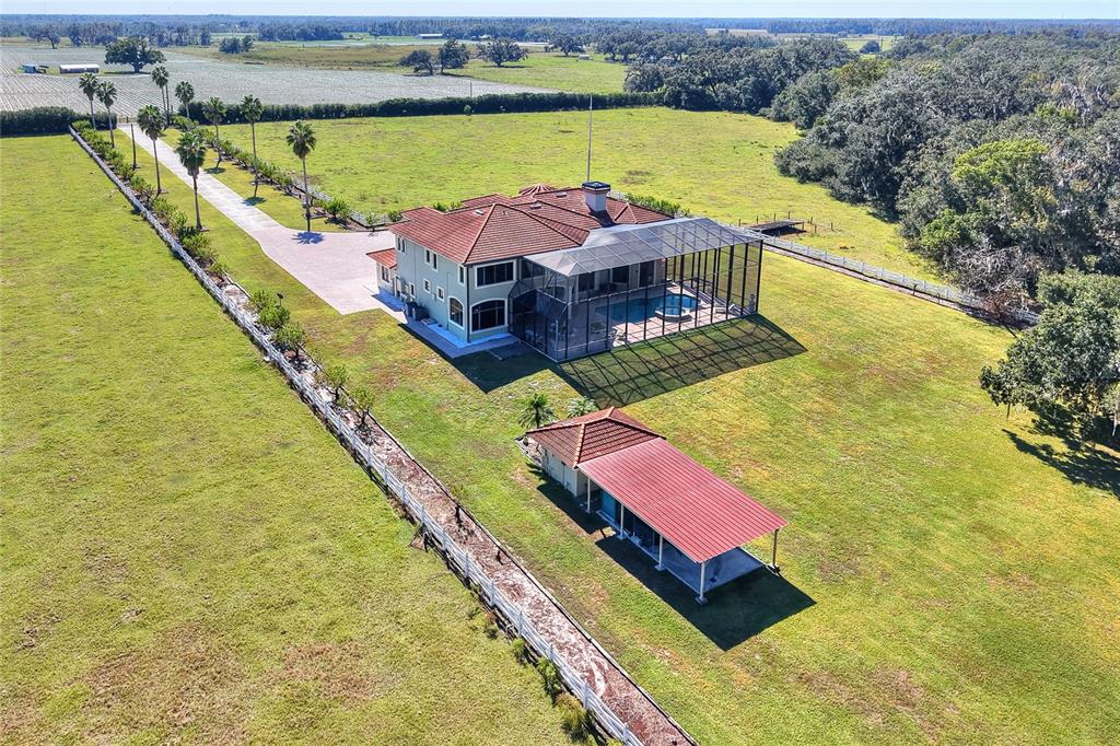 An aerial view shows a house with a pool enclosure and a detached carport — 4215 S B MERRION ROAD, LAKELAND, FL