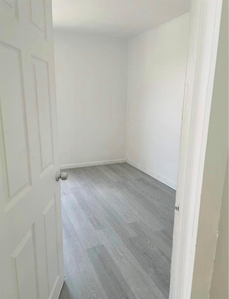 An empty room with white walls and light gray wood-look flooring — 706 7th Street, West Palm Beach FL 33401, WEST PALM BEACH, FL