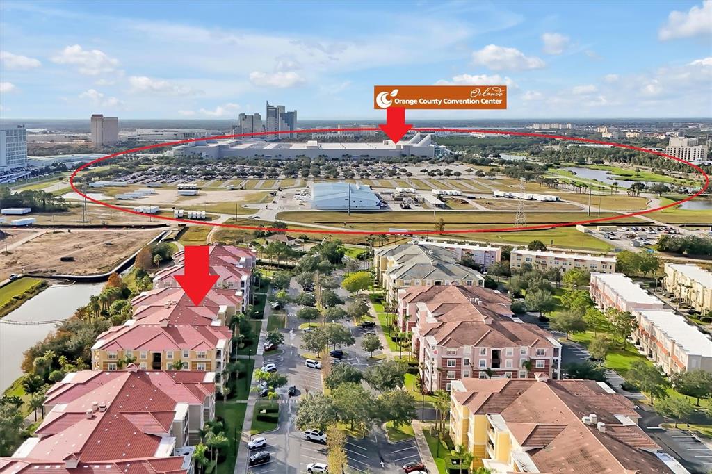 This aerial view shows a residential apartment complex with red roofs near the Orange County Convention Center — 5036 SHOREWAY LOOP UNIT 30105, ORLANDO, FL