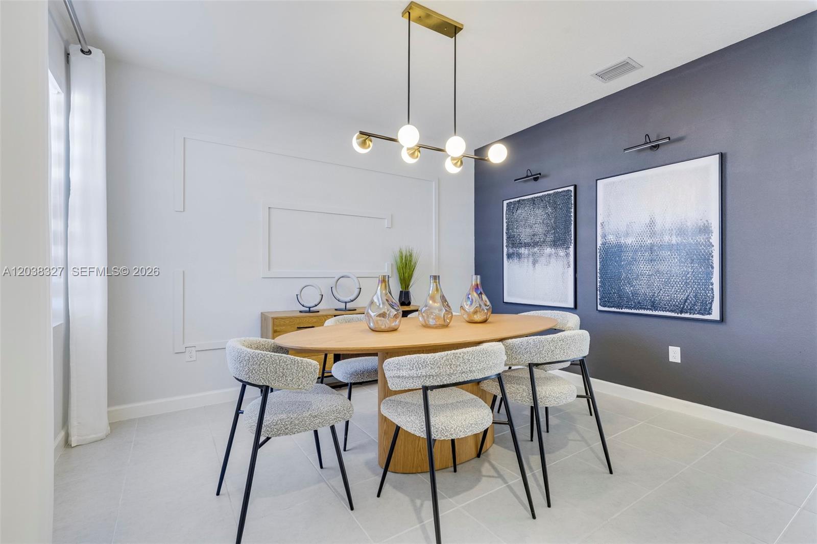A modern dining room features an oval wooden table, textured chairs, and a dark accent wall — 35624 SW 178 PL, Miami FL 33034, MIAMI, FL
