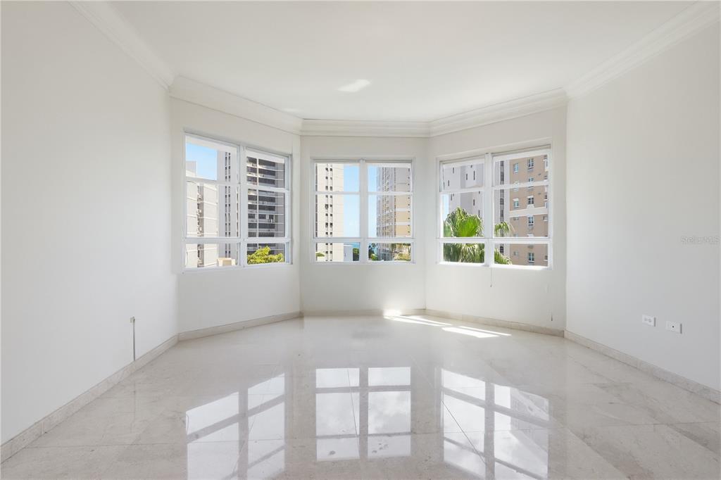 An empty room with white walls, marble flooring, and a large bay window — 1754 MCCLEARY AVENUE UNIT 602, SAN JUAN, PR