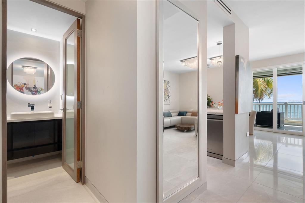 A hallway with a bathroom, a full-length mirror, and a view into a living area — 400 OCEAN DRIVE UNIT 423, HUMACAO, PR
