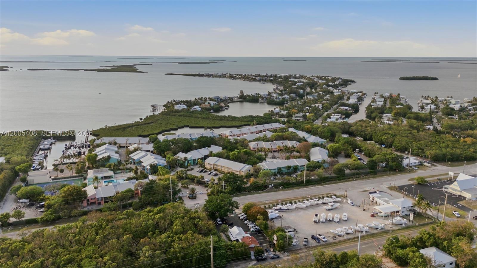 An aerial view shows a coastal residential complex, a boat storage lot, and surrounding water — 98282 Windward Ave # 2, Key Largo FL 33037, KEY LARGO, FL