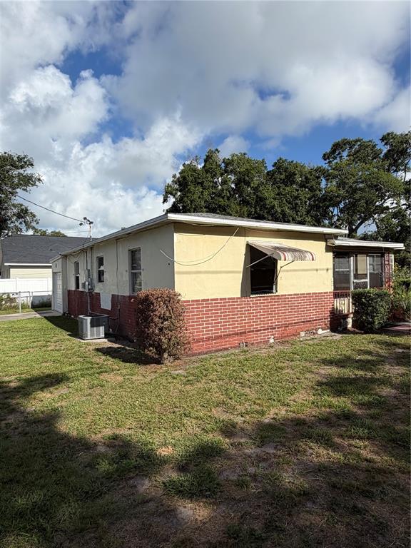 A single-story house with a yellow stucco upper section and a red brick lower exterior — 1010 PENNSYLVANIA AVENUE, CLEARWATER, FL