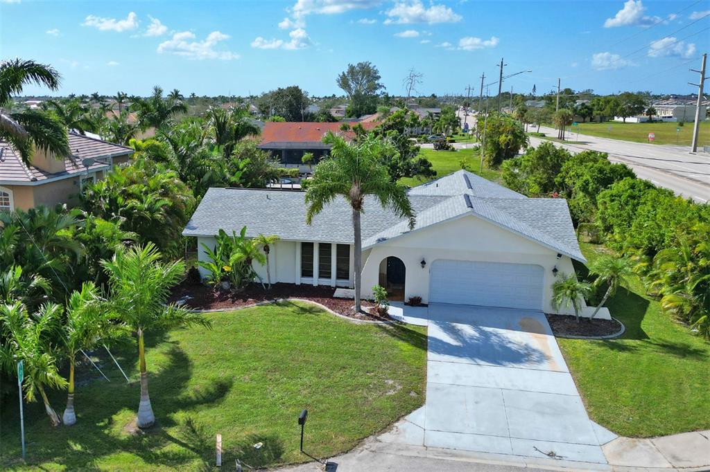 An aerial view of a single-story house with a gray roof and a concrete driveway — 4800 SW 12TH PLACE, CAPE CORAL, FL
