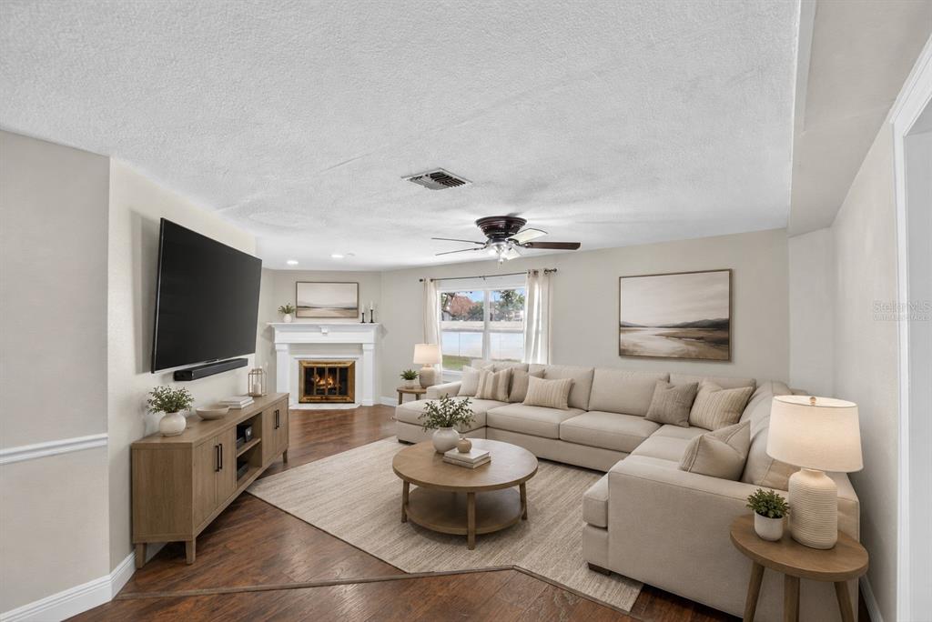 A kitchen features dark wood cabinets, granite countertops, a center island, and white appliances — 918 JERE CIRCLE, LAKELAND, FL