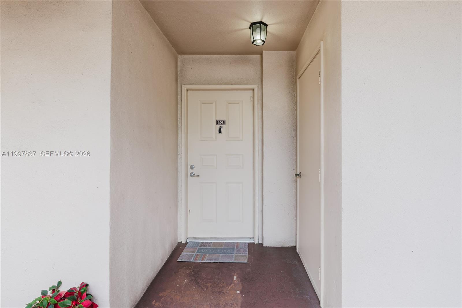 An exterior entryway features a white door labeled 101, a small welcome mat, and lighting — 101 SW 96th Ter # 101, Plantation FL 33324, PLANTATION, FL